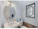 Charming half-bathroom featuring a decorative window, toilet and stylish fixtures at 5451 Oakhurst Dr, Seminole, FL 33772