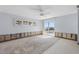 Light-filled bedroom with a ceiling fan and sliding door leading to waterfront views at 5451 Oakhurst Dr, Seminole, FL 33772