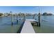 A modern dock extends into the water, complete with a boat lift for easy water access and a great way to enjoy waterfront living at 5451 Oakhurst Dr, Seminole, FL 33772