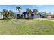 Beautiful home exterior with well-manicured lawn, mature trees, and a welcoming entrance and great curb appeal at 5451 Oakhurst Dr, Seminole, FL 33772