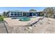 A kidney-shaped pool and jacuzzi are surrounded by a patio, with the waterfront in the background at 5451 Oakhurst Dr, Seminole, FL 33772