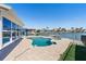 A beautiful kidney-shaped pool and jacuzzi offer a luxurious outdoor living space and a wonderful view of the waterfront at 5451 Oakhurst Dr, Seminole, FL 33772