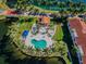 Aerial view of a community pool and patio area surrounded by tropical landscaping and waterway at 5900 Bahia Del Mar Cir # 137, St Petersburg, FL 33715