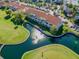 An aerial view showcasing residences and a golf course with a tranquil water feature at 5900 Bahia Del Mar Cir # 137, St Petersburg, FL 33715