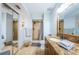Modern bathroom featuring granite countertop vanity, walk-in shower, and mirrored closet doors at 5900 Bahia Del Mar Cir # 137, St Petersburg, FL 33715