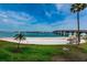 Scenic beach view with white sand, palm trees, blue water, and a bridge in the distance at 5900 Bahia Del Mar Cir # 137, St Petersburg, FL 33715