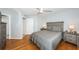 Comfortable bedroom with hardwood floors, ceiling fan, a queen bed, and a view of the bathroom at 5900 Bahia Del Mar Cir # 137, St Petersburg, FL 33715