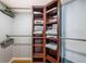 Walk-in closet with wood shelving unit, hanging rods and organized towels at 5900 Bahia Del Mar Cir # 137, St Petersburg, FL 33715