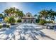 A grand clubhouse entrance framed by palm trees and steps, with seating around the pool at 5900 Bahia Del Mar Cir # 137, St Petersburg, FL 33715