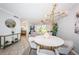 Open concept dining room featuring a modern chandelier and seating for four at 5900 Bahia Del Mar Cir # 137, St Petersburg, FL 33715