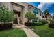 Well-maintained condo exterior with mature landscaping and sidewalk, offering a welcoming entrance at 5900 Bahia Del Mar Cir # 137, St Petersburg, FL 33715