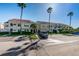 Condominium building featuring a tile roof, landscaping, stairs to second level units and ample parking at 5900 Bahia Del Mar Cir # 137, St Petersburg, FL 33715