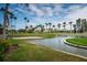 Beautiful golf course featuring palm trees, serene water, and green grass under a blue sky at 5900 Bahia Del Mar Cir # 137, St Petersburg, FL 33715
