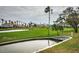 Scenic view of a lush golf course with palm trees and water features under a cloudy sky at 5900 Bahia Del Mar Cir # 137, St Petersburg, FL 33715
