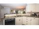 Well-lit kitchen with granite counters, modern appliances, and view of the living area and backyard at 5900 Bahia Del Mar Cir # 137, St Petersburg, FL 33715
