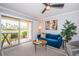 Open living room with a view to the patio and tropical scenery at 5900 Bahia Del Mar Cir # 137, St Petersburg, FL 33715