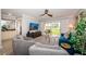 Comfortable living room with gray armchairs, blue sofa, and sliding doors to the outside at 5900 Bahia Del Mar Cir # 137, St Petersburg, FL 33715
