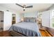 Well-furnished main bedroom with hardwood floors, a ceiling fan, and comfortable queen bed at 5900 Bahia Del Mar Cir # 137, St Petersburg, FL 33715
