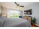 Comfortable main bedroom with plush bedding, ceiling fan, and natural light from the windows at 5900 Bahia Del Mar Cir # 137, St Petersburg, FL 33715