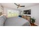 Cozy main bedroom with a view of the backyard and a large television for viewing enjoyment at 5900 Bahia Del Mar Cir # 137, St Petersburg, FL 33715