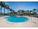Large community pool is surrounded by palm trees and lounge chairs at 5900 Bahia Del Mar Cir # 137, St Petersburg, FL 33715
