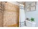 Walk-in shower with gray and white shower curtain, decorative wall flowers, and chrome fixtures at 5900 Bahia Del Mar Cir # 137, St Petersburg, FL 33715