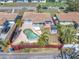 Aerial view of fenced backyard with a uniquely shaped private pool, mature landscaping, and patio area at 6618 3Rd N Ave, St Petersburg, FL 33710