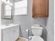 Bathroom featuring a modern sink, a toilet, and a cabinet for storage at 6618 3Rd N Ave, St Petersburg, FL 33710