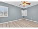 Bright bedroom featuring light wood floors, a ceiling fan and windows with blinds at 6618 3Rd N Ave, St Petersburg, FL 33710