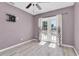 Bedroom with a ceiling fan, light floors, a tv mount and a french door leading to the backyard at 6618 3Rd N Ave, St Petersburg, FL 33710