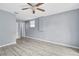 Spacious bedroom with light-colored walls, a ceiling fan, and modern flooring at 6618 3Rd N Ave, St Petersburg, FL 33710