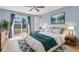 Cozy bedroom with a sliding glass door to the backyard, a ceiling fan, and stylish décor at 6618 3Rd N Ave, St Petersburg, FL 33710