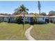Well-manicured front yard with lush landscaping and a charming walkway, creating a welcoming entrance at 6618 3Rd N Ave, St Petersburg, FL 33710