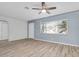 A bright living room featuring a ceiling fan, wood-look floors, and a window for natural light at 6618 3Rd N Ave, St Petersburg, FL 33710