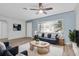 A cozy living room features stylish furniture, a ceiling fan, and a bright window at 6618 3Rd N Ave, St Petersburg, FL 33710