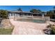 Backyard pool with brick patio and partial fence, perfect for enjoying outdoor living and entertaining guests at 6618 3Rd N Ave, St Petersburg, FL 33710