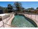 Beautifully maintained pool featuring a fountain, surrounded by a brick patio and safety fence at 6618 3Rd N Ave, St Petersburg, FL 33710