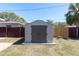 Backyard features a storage shed with double doors, providing ample space for tools and equipment at 6618 3Rd N Ave, St Petersburg, FL 33710