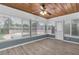 The sunroom has natural light, wood ceiling, and laminate floors at 6618 3Rd N Ave, St Petersburg, FL 33710