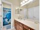Bathroom featuring wood vanity with a white countertop and blue shower curtain at 7100 Islamorada Cir, Seminole, FL 33777