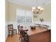 Cozy dining room featuring hardwood floors, a chandelier, and natural light at 7100 Islamorada Cir, Seminole, FL 33777