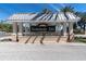 Community entrance sign reading 'Seminole Isle,' set against a backdrop of a sunny sky at 7100 Islamorada Cir, Seminole, FL 33777