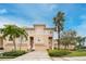 Inviting townhouse with beige exterior, palm trees and well-maintained landscaping at 7100 Islamorada Cir, Seminole, FL 33777