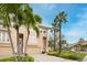 Exterior view of a multi-unit building with a well-manicured lawn and palm trees at 7100 Islamorada Cir, Seminole, FL 33777