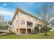Rear exterior view of the property, showing a porch and well-maintained lawn at 7100 Islamorada Cir, Seminole, FL 33777