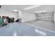 Spacious garage with epoxy flooring and ample storage space at 7100 Islamorada Cir, Seminole, FL 33777