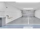 A spacious two car garage with an epoxy floor and utility sink at 7100 Islamorada Cir, Seminole, FL 33777