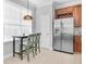 Breakfast nook in the kitchen features an eating area and stainless steel refrigerator near a bright window at 7100 Islamorada Cir, Seminole, FL 33777