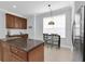 Spacious kitchen boasts a breakfast nook, stainless steel refrigerator, and a granite-topped center island at 7100 Islamorada Cir, Seminole, FL 33777