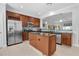 Beautiful kitchen with stainless steel appliances, center island, tile backsplash, and ample cabinet space at 7100 Islamorada Cir, Seminole, FL 33777